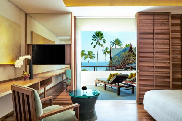 Stylish resort accommodation featuring a cosy bedroom with a spacious bed, and warm lighting.