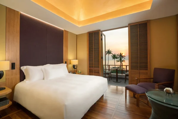 Inviting resort accommodation in Juniper Suite featuring a spacious bedroom with a large bed, and sunrise view.