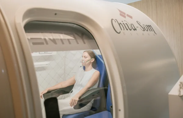 A woman relaxes inside a hyperbaric chamber for therapy treatment in Hua Hin resort.